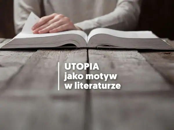 Otwarta księga na drewnianym stole, a na niej tekst: "UTOPIA jako motyw w literaturze". Czytanie o tym, utopia co to, otwiera drzwi do wyobraźni.